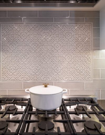 A kitchen with a stove and a backsplash.