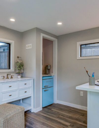 A small room with a desk and a pink chair.